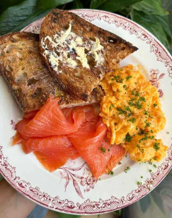 Plate of scrambled eggs, smoked salmon and buttered toast